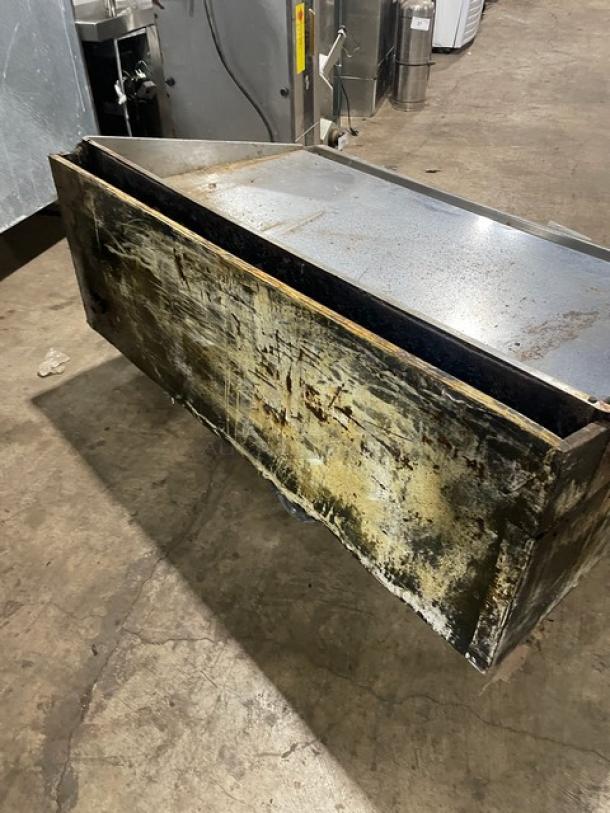 Commercial stainless steel natural gas countertop flat griddle with back and side splash; mounted on legs; well-used condition.
