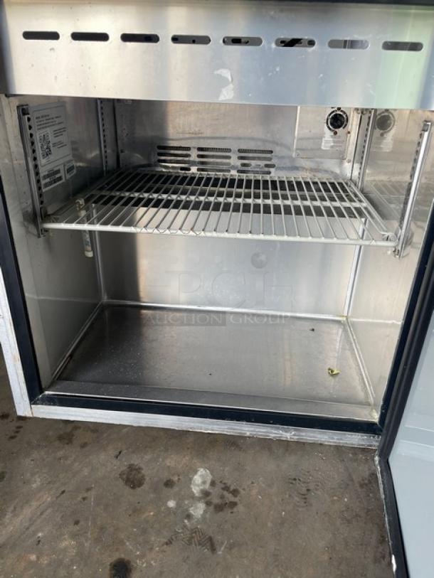Turbo Air MST-28-711S prep table interior, stainless steel, poly coated wire rack, clean condition, model label visible.