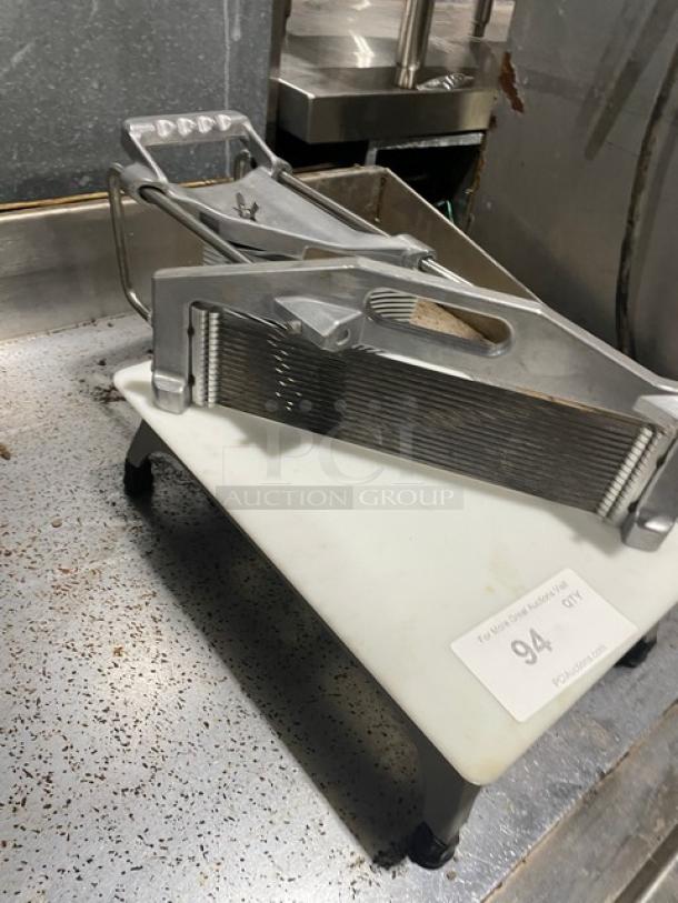 Heavy duty countertop tomato and vegetable slicer with easy slice cutting board, mounted on legs, in good condition.