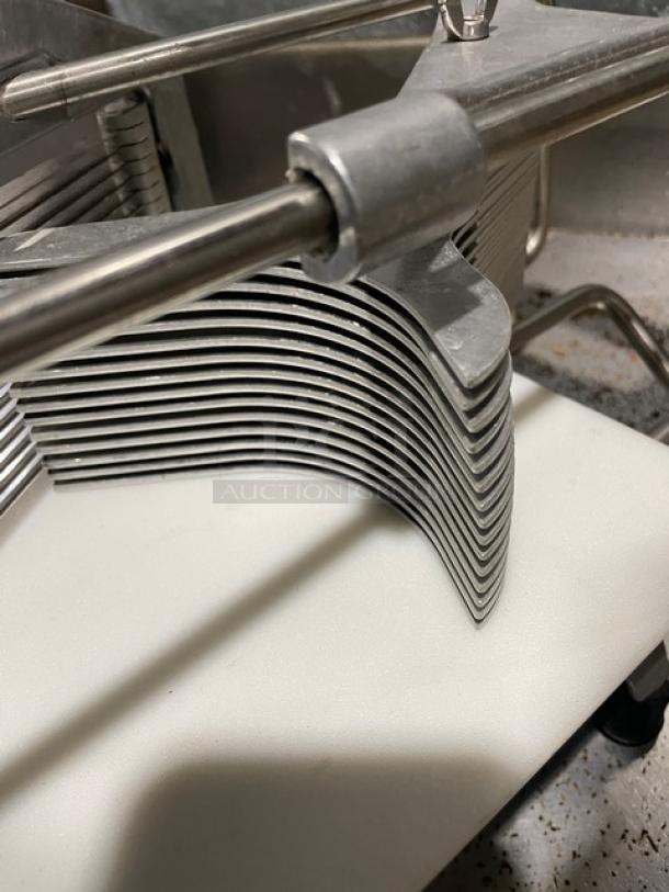 Commercial heavy duty countertop slicer with stainless steel blades and easy-slice cutting board, mounted on sturdy legs.
