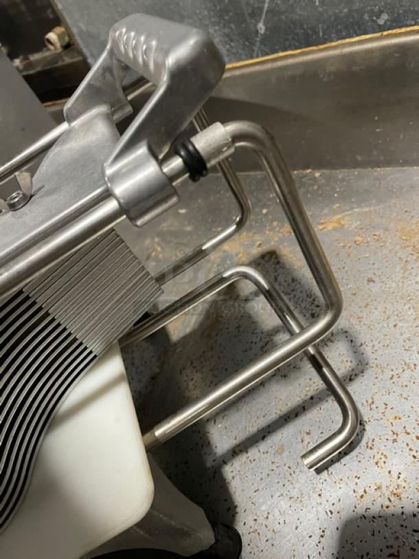 Commercial heavy-duty countertop tomato and vegetable slicer with easy slice cutting board. Sturdy metal legs, used condition.