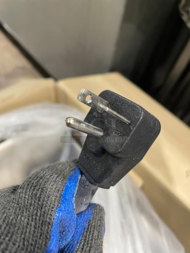 Close-up image of a power plug for the Menumaster RFS12TSW commercial microwave, 120V, new condition.