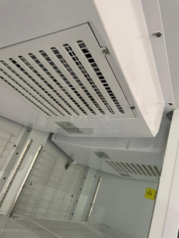 Kool-It Signature Series commercial refrigerator interior, white walls, poly-coated wire racks, visible vents, SN: H89228500756.