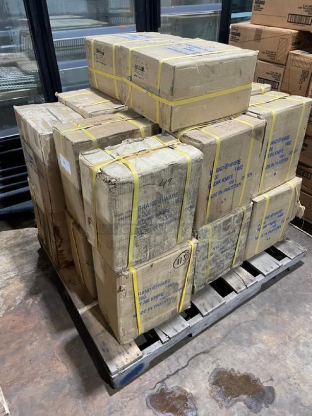 Pallet of Brand Ware Model 2001482 steak knives, 100 dozen per case, stainless steel, wooden grip, in original packaging.