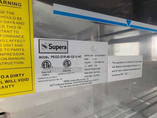 Supera two-section door merchandiser, model PEGD-2DR-48-ES-SI-HC, with ETL certifications and usage instructions visible.
