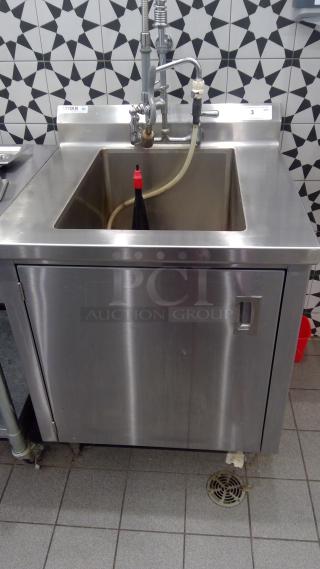 Titan 30" stainless steel sink with integrated cabinet. Features durable finish, faucet, and spray hose. Good condition.