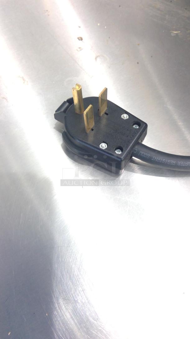 Power plug for Practica Copa Express high-speed oven. Features three brass pins and a black cord. Clean and well-maintained.