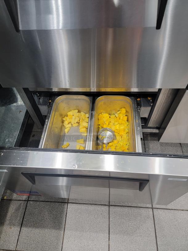 Turbo Air TWR-48SD-D4-N undercounter fridge, stainless steel, 4 drawers, shown with open drawer containing food pans.