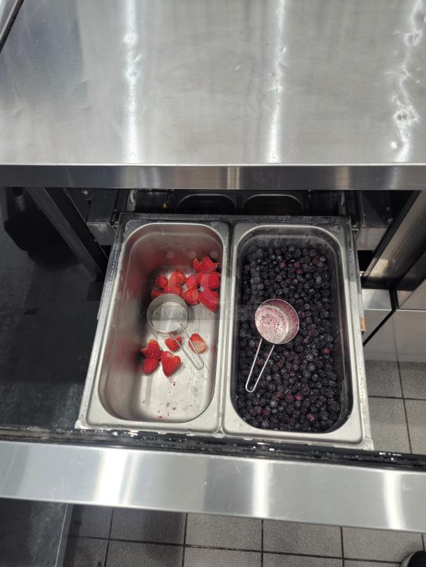 Turbo Air TWR-48SD-D4-N undercounter fridge with stainless steel top, open drawer showing strawberries and blueberries in trays.
