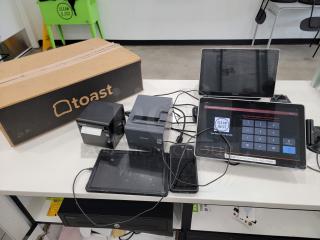 Complete Toast POS system including tablets, printers, and accessories on a countertop. Ideal for restaurants and cafes.