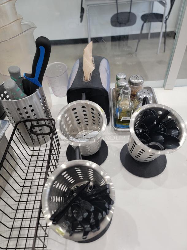 Restaurant kitchen essentials lot with utensil holders, napkin dispenser, and condiments; good used condition.