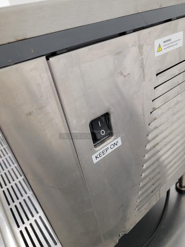Crathco D35-4 beverage dispenser, stainless steel finish, moderate wear. Visible "Keep On" label near switch. Ideal for chilled drink service.