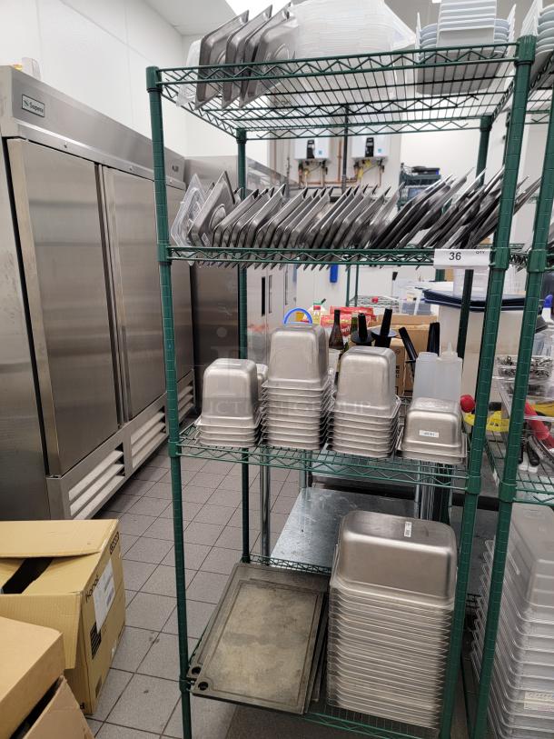 Commercial kitchen lot with stainless pans, containers, and Metro shelving for organization and food prep. Ideal for restaurants.