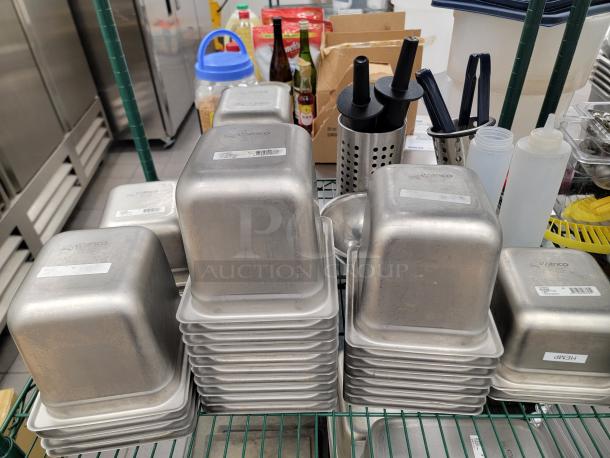 Stainless steel pans and containers on a green Metro shelf, ideal for commercial kitchens. Includes utensils and squeeze bottles.