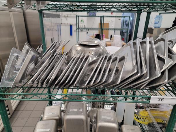 Commercial kitchen storage lot with stainless pans, containers, and Metro shelve. Ideal for restaurants. Good condition.