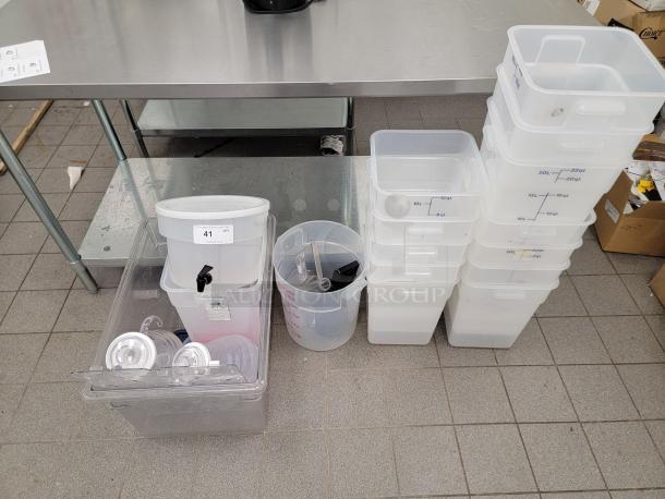 Assorted kitchen essentials lot with commercial-grade translucent food storage containers, beverage dispensers; ideal for restaurants.