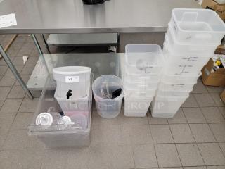 Assorted kitchen essentials lot with commercial-grade translucent food storage containers, beverage dispensers; ideal for restaurants.