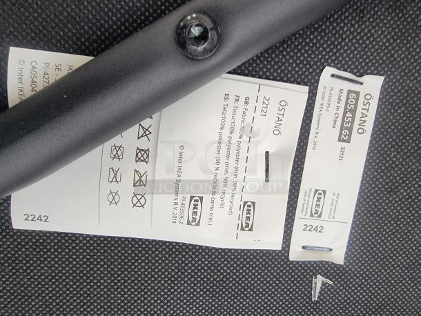 IKEA ÖSTANÖ chair labels, showing model 605.453.62, fabric details, and care instructions.