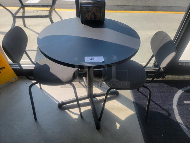 IKEA round dining table with three matching chairs, black finish, 27" diameter. Perfect for small spaces, modern design.