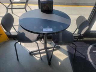 IKEA round dining table with three matching chairs, black finish, 27" diameter. Perfect for small spaces, modern design.