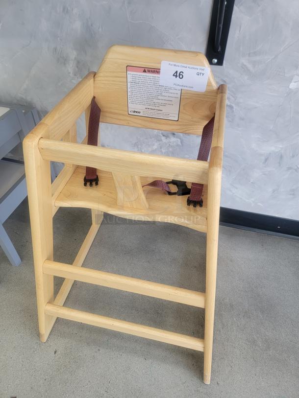 Winco Natural Wood Commercial High Chair with safety straps and ASTM compliance label, ideal for restaurants and daycares.
