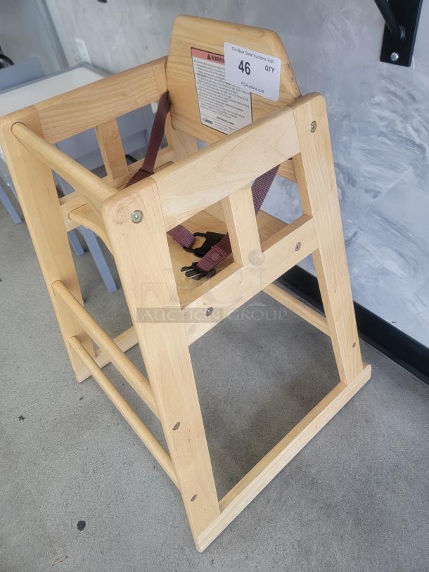 Winco Natural Wood Commercial High Chair, ASTM compliant, sturdy build, brown straps, safety warnings and auction label visible.