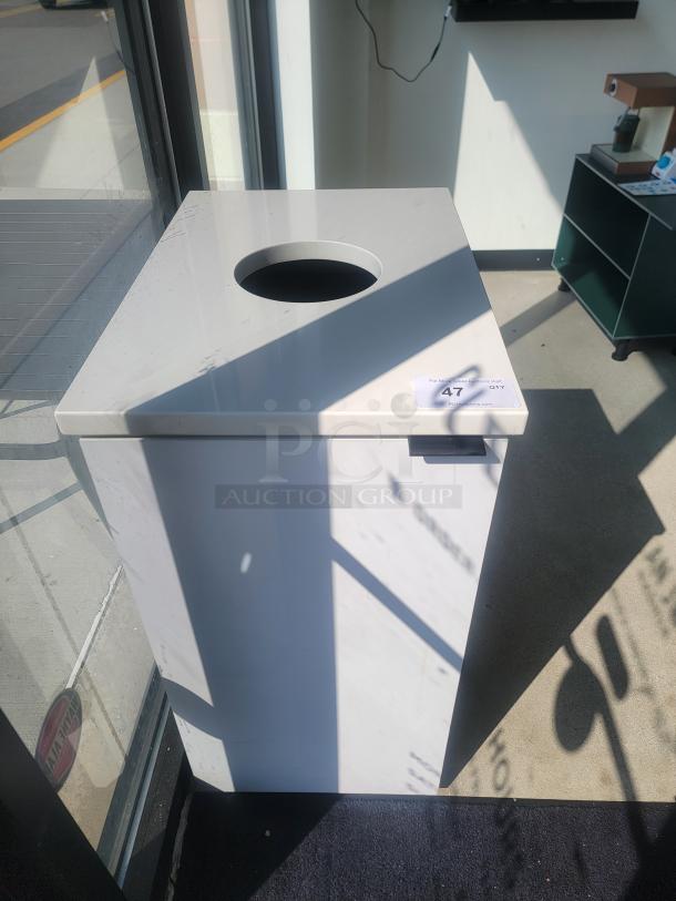 Modern white indoor commercial waste receptacle on casters, square shape with top opening, label reads "47 QTY." Perfect for offices.