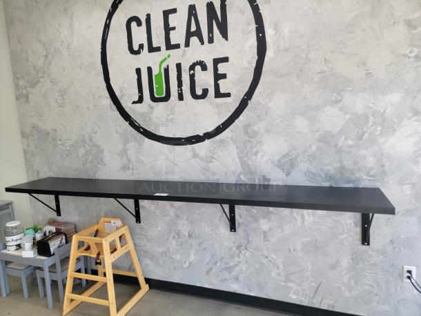 Extra long 10-foot black wall-mounted display shelf, commercial grade, attached with metal brackets, ideal for retail use.