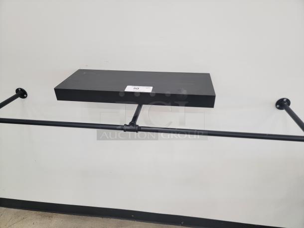 Modern black 2-foot wall-mounted display shelf with industrial-style brackets, in excellent condition. Perfect for compact spaces.