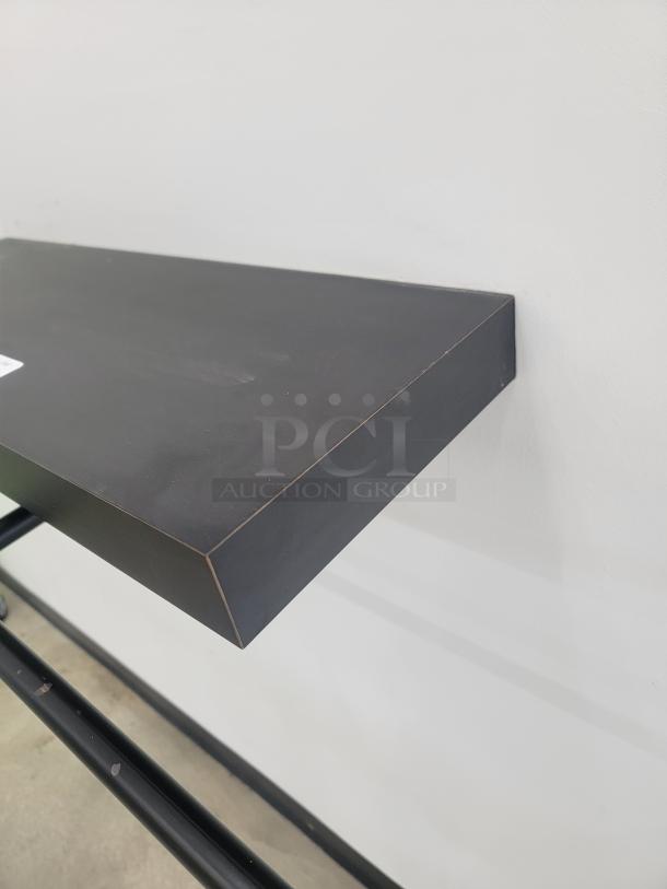 Modern 2-foot wall-mounted black display shelf. Sleek design, perfect for organizing small spaces. Excellent condition.