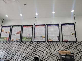 14-foot commercial menu board system with 6 detachable 26x38-inch signs for customizable restaurant menus.