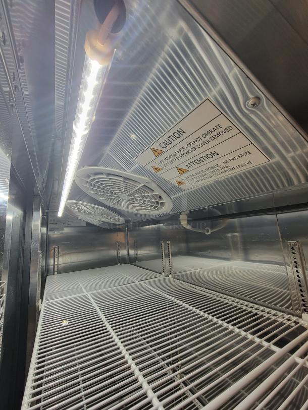 Turbo Air M3R72-3-N 3-door commercial refrigerator interior showing shelves and warning label, excellent condition.