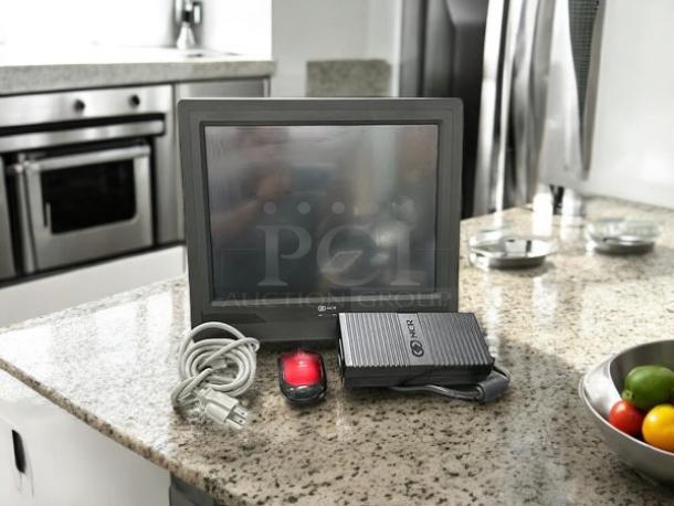 Semi-new NCR Model 7610-5020-8801 POS terminal by Intel on countertop, with cables and red device, fully tested and working.