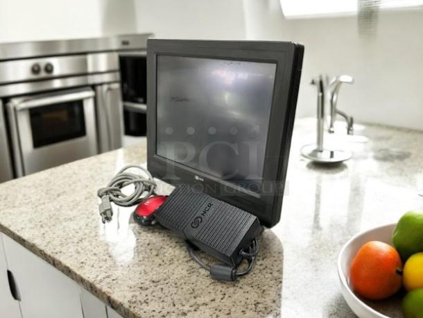 Semi-new NCR Model 7610-5020-8801 POS terminal by Intel, tested and working, with power cord and accessories on a countertop.