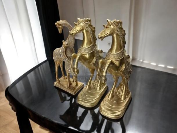 Rosdorf Park Azelea Animals Figurines & Sculptures, like new, featuring detailed gold horse and deer designs on a polished table.