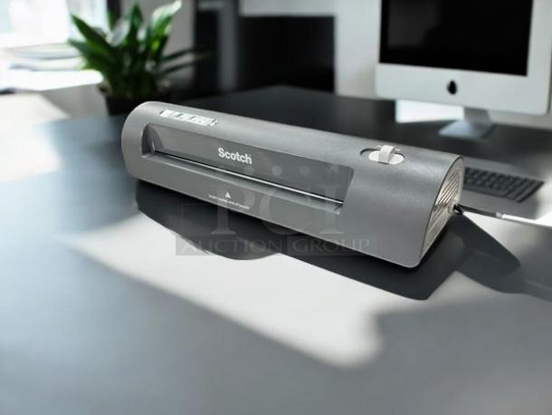 Brand new Scotch TL901X thermal laminator on a desk, featuring a sleek design and brand label on top.
