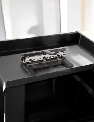 Swingline SWI450 hole punch machine on black surface, featuring adjustable metal components, in good condition.