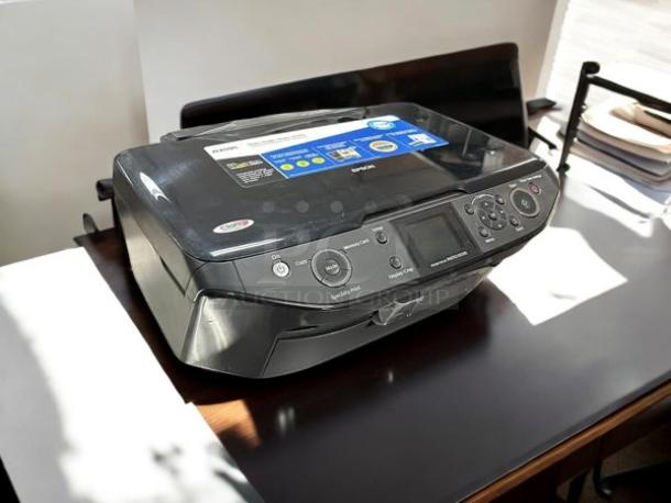 Epson Stylus Photo RX595 printer in excellent condition, fully tested. Features a digital display, control panel, and visible model label.