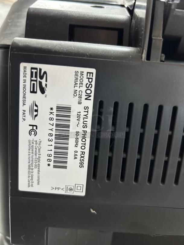 Epson Stylus Photo RX595 printer, model C281B, shown with label displaying specs and serial number, in great condition.