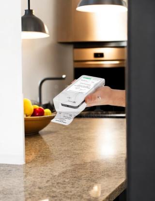Clover Flex K400 in great condition, fully tested, handheld on a kitchen counter, displaying a receipt printout.