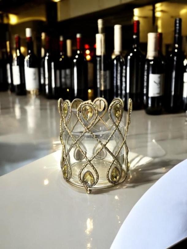 Gold metal small candle holder with intricate lattice design, excellent condition, no visible marks. Elegant, decorative item.