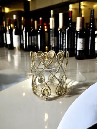 Gold metal small candle holder with intricate lattice design, excellent condition, no visible marks. Elegant, decorative item.