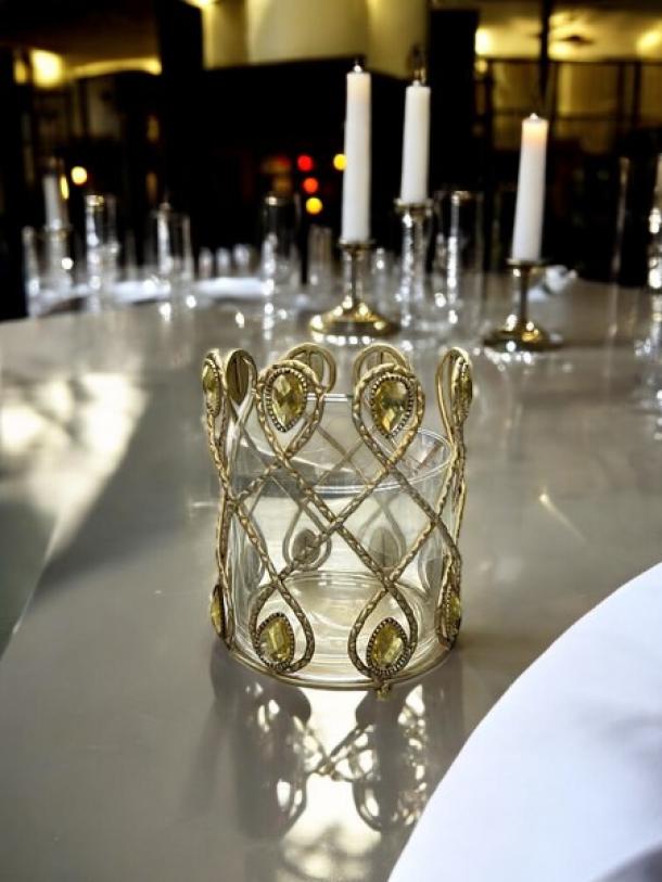 Small candle holder with ornate gold lattice design and teardrop accents. Excellent condition, elegant display item.