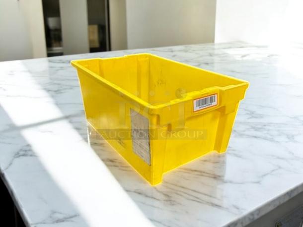 Yellow plastic storage container in great condition, features a barcode label and a side sticker on marble surface.