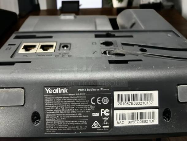 Yealink SIP-T53W phone, back view, ports visible, branded label stating model, FCC and CE certified, MAC address shown.
