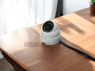 Dahua HDCVI security camera, white, in excellent condition, fully tested and working, shown with cable on wooden surface.