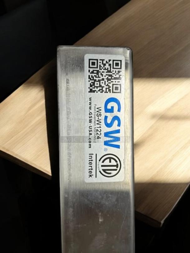 GSW W1224 24” wall mount stainless steel shelf, fully tested, excellent condition. Visible label with brand and model details.