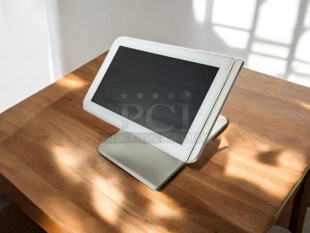 Clover C100 Touchscreen POS System in excellent condition on wooden table; sleek design, fully tested and working.