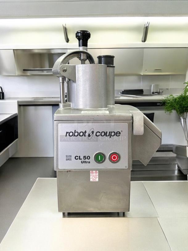 Robot Coupe CL50 food processor in perfect condition, with 3 discs, 1 1/2 hp, tested and working. Front panel shows the model and controls.