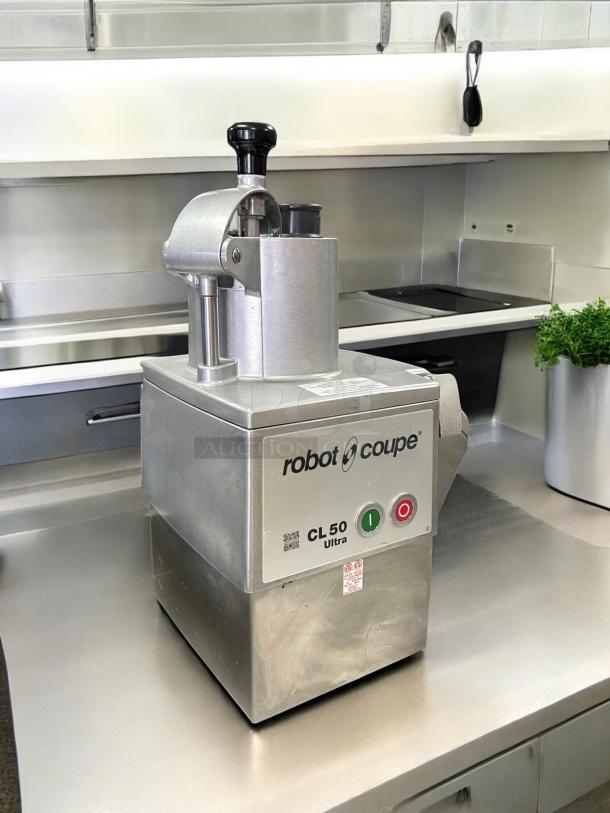 Robot Coupe CL50 food processor, perfect condition, 1 1/2 hp, includes 3 discs, tested and working, with visible brand label.